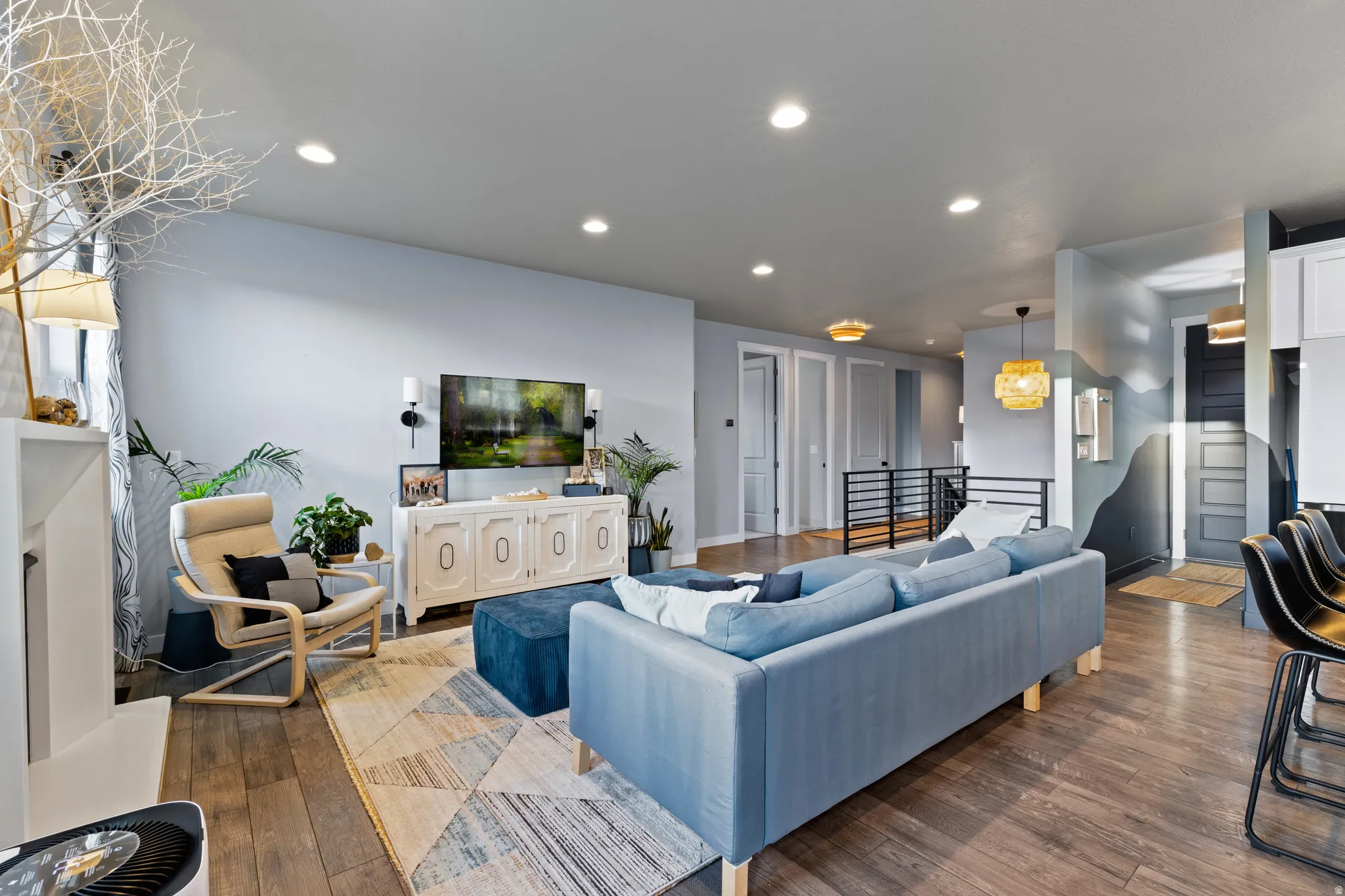 Living area with wood-type flooring and recessed lighting