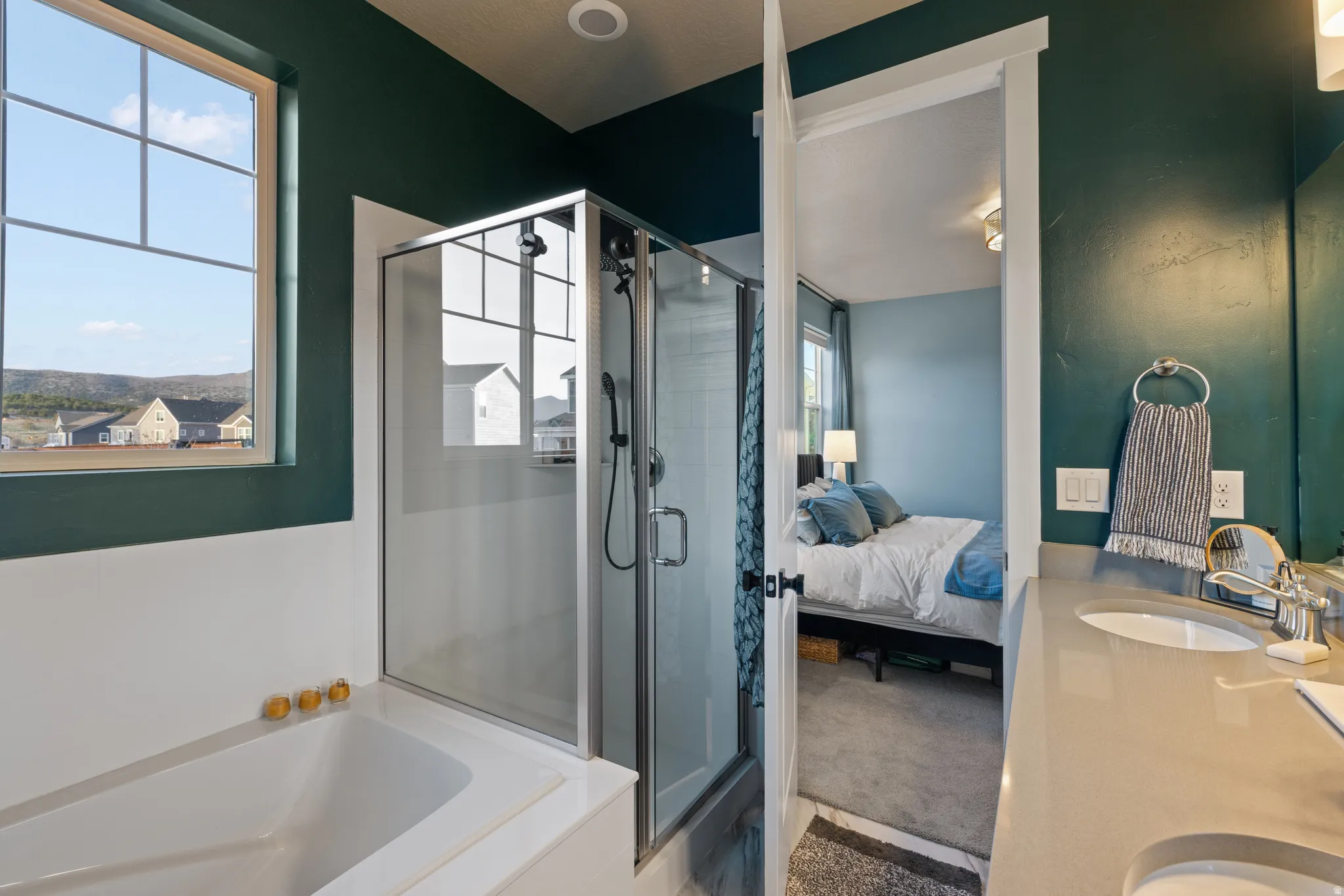 Bathroom with ensuite bathroom, vanity, a bath, and a shower stall