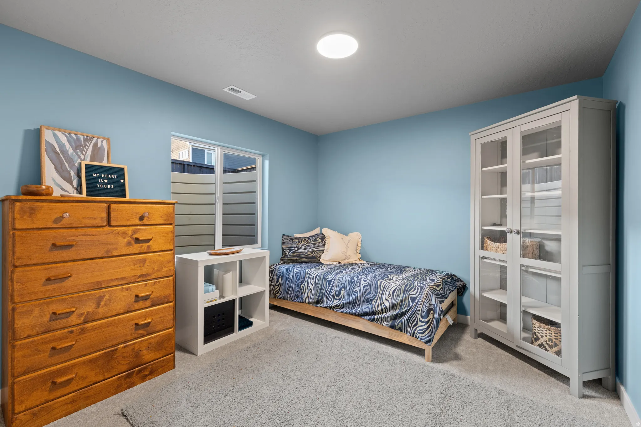 Bedroom featuring light colored carpet