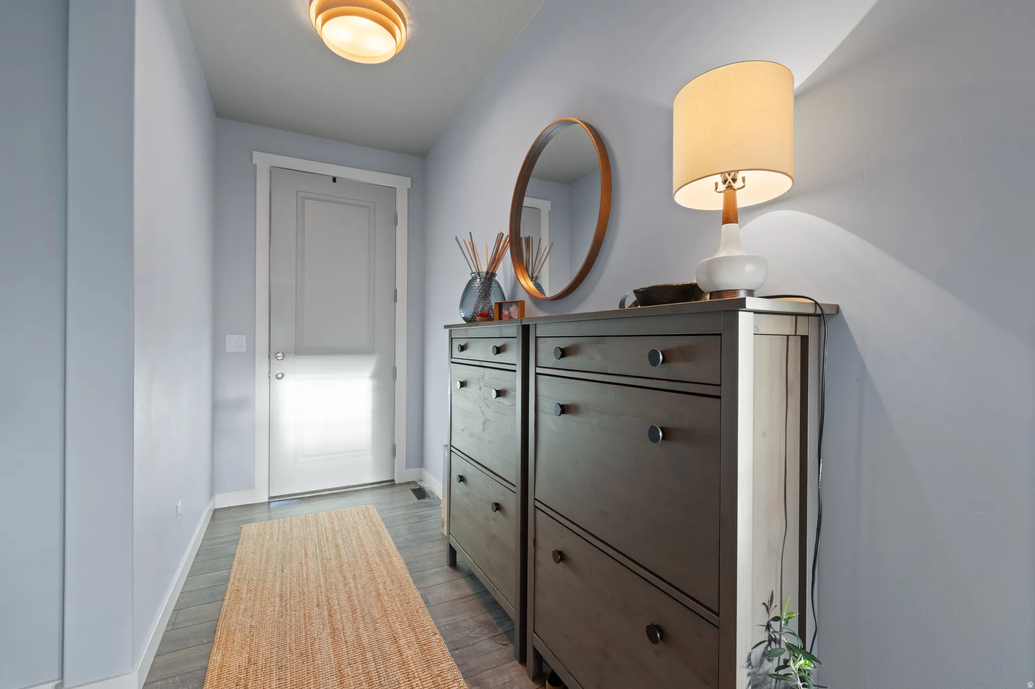 Hallway featuring baseboards and light wood finished floors