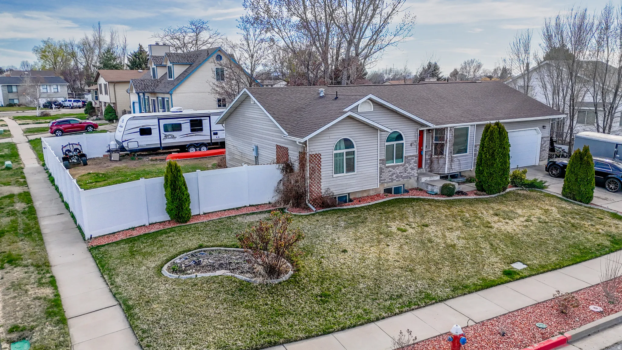 View of front of home featuring a shingled roof, an attached garage, and a residential view