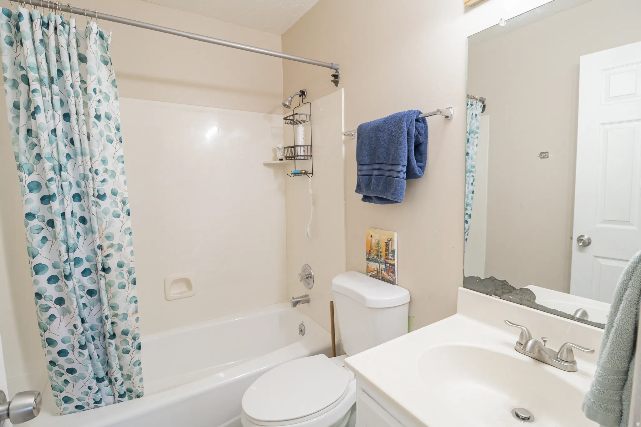 Bathroom featuring shower / bath combo and vanity
