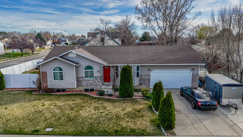Ranch-style house featuring concrete driveway, an attached garage, and a shingled roof