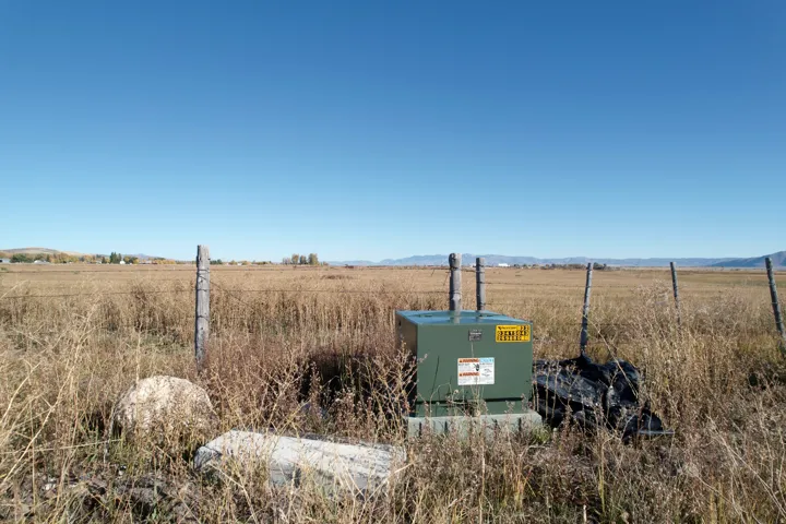 Exterior view of a pad mount transformer and a mountain backdrop