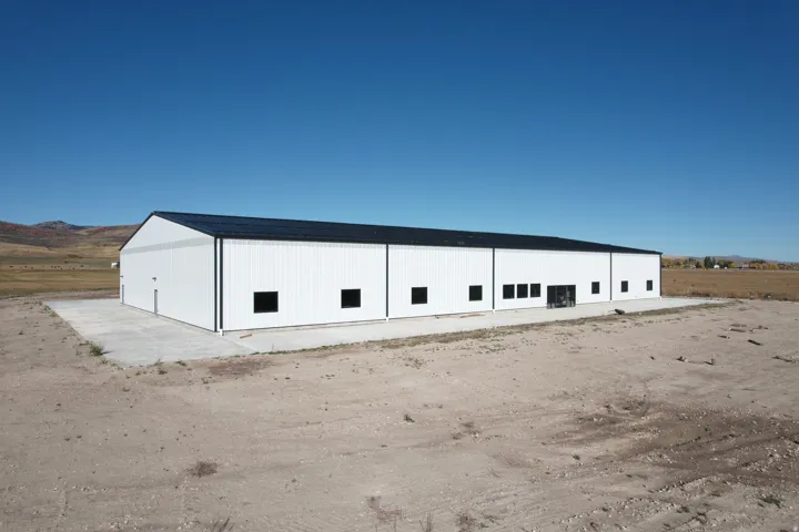 View of building exterior featuring a mountain view, a pole building, and a view of countryside