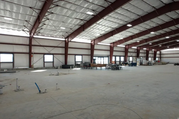 Miscellaneous room featuring a high ceiling and metal wall