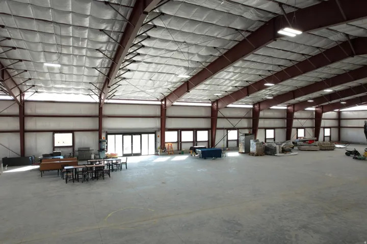 Miscellaneous room featuring a high ceiling and metal wall