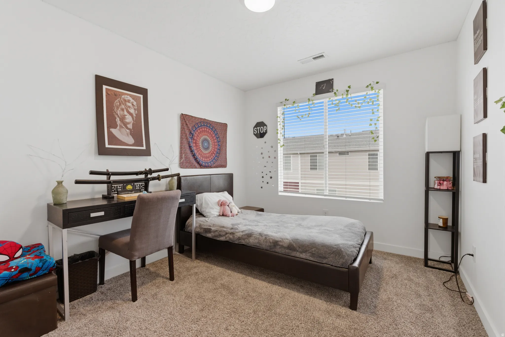 Bedroom featuring light colored carpet and baseboards