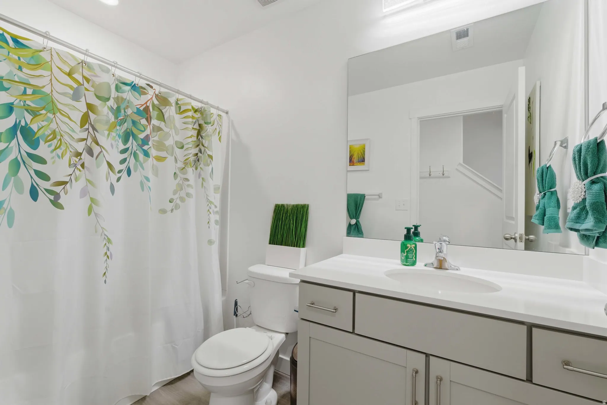 Bathroom featuring vanity and curtained shower