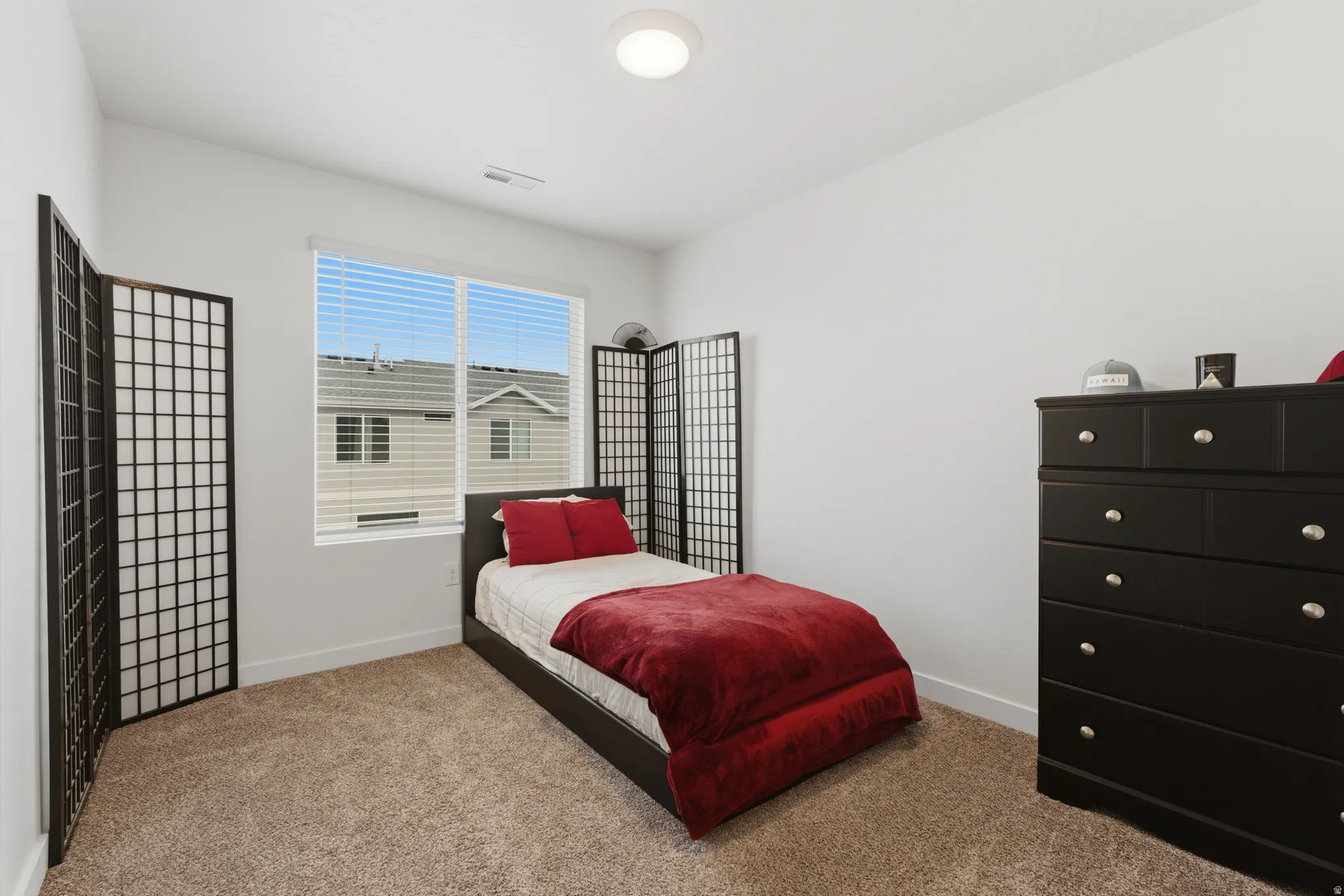 Bedroom featuring light carpet
