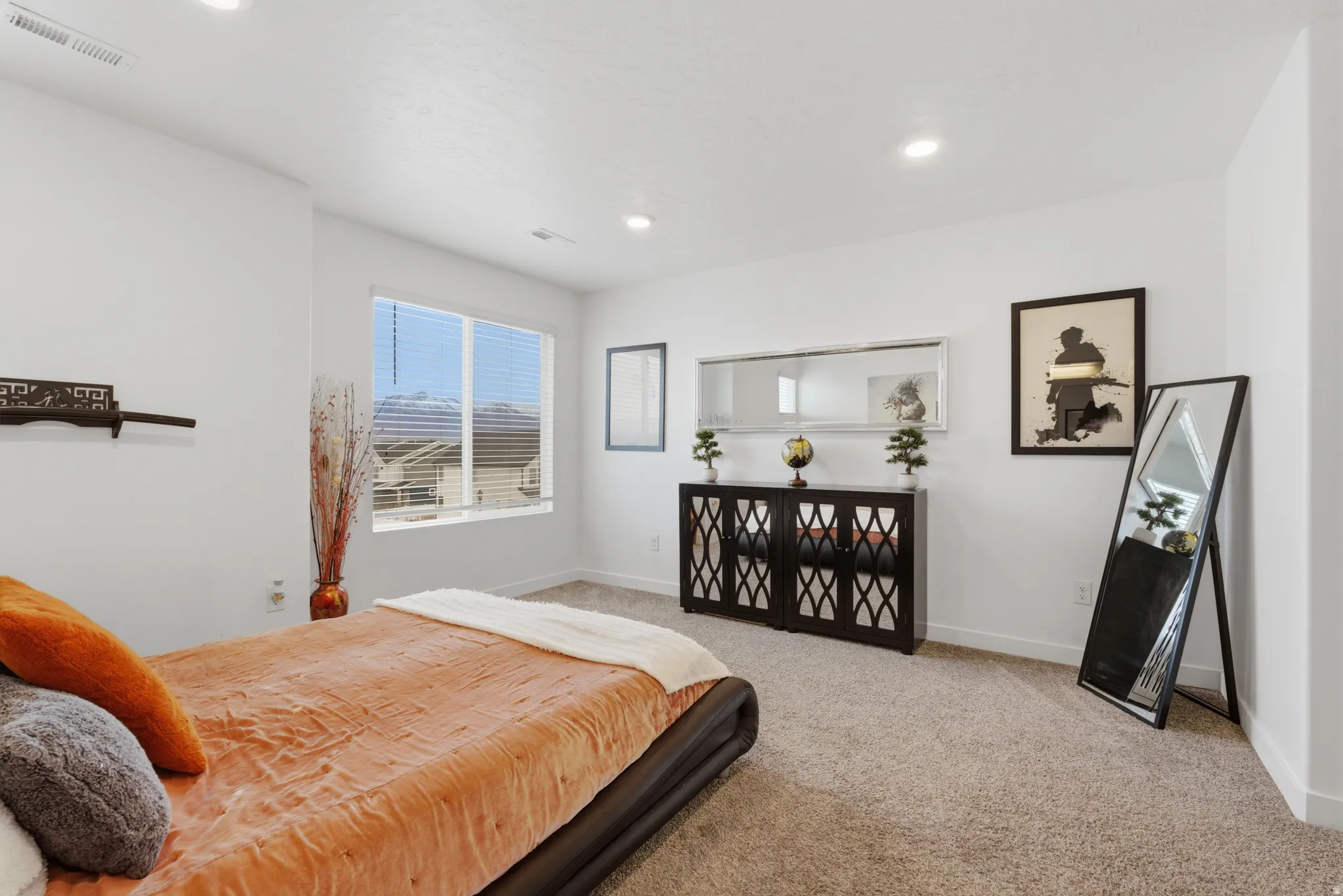Bedroom with light colored carpet and recessed lighting