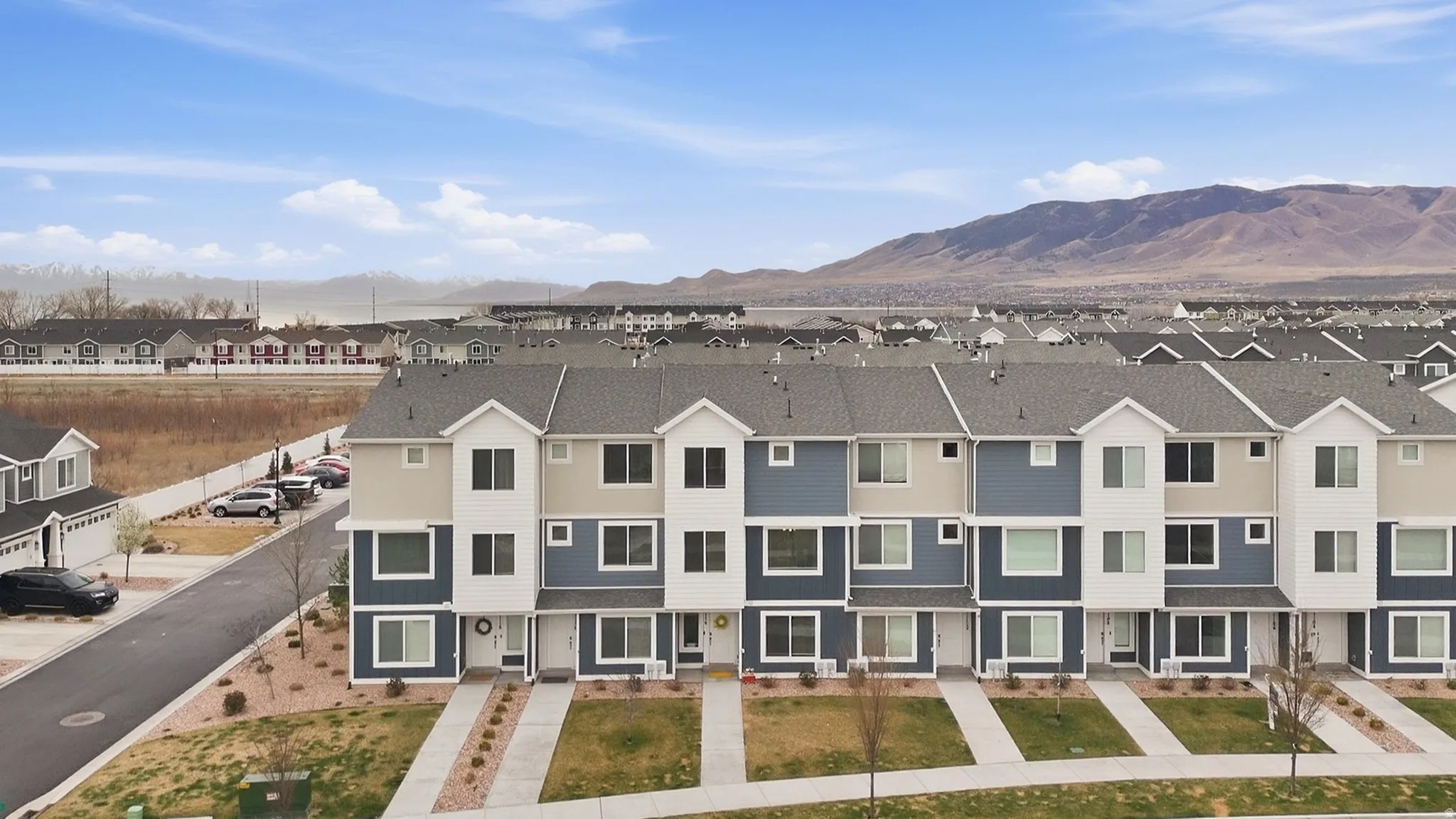 Aerial view of residential area featuring a mountainous background