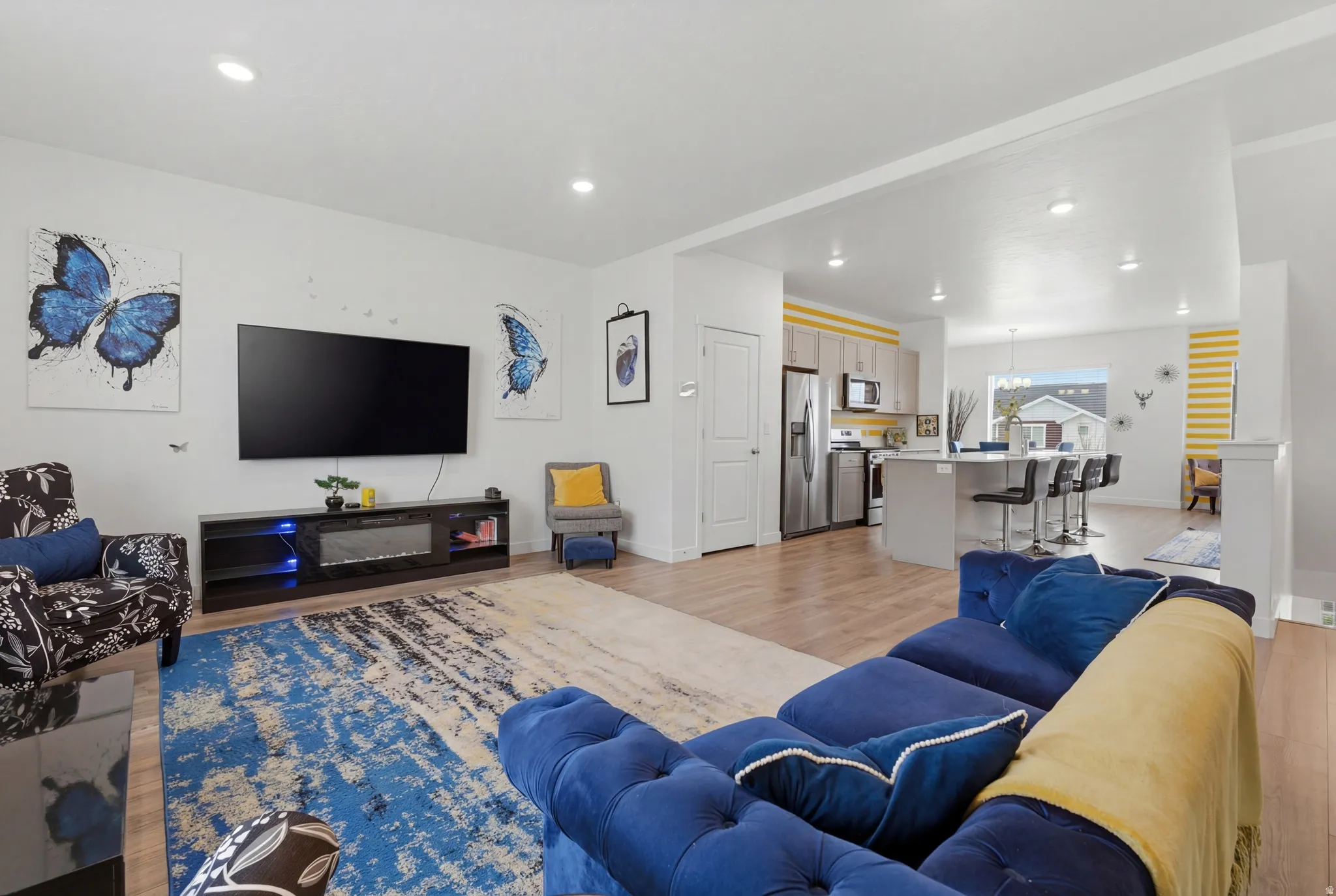 Living room featuring light wood-style flooring and recessed lighting