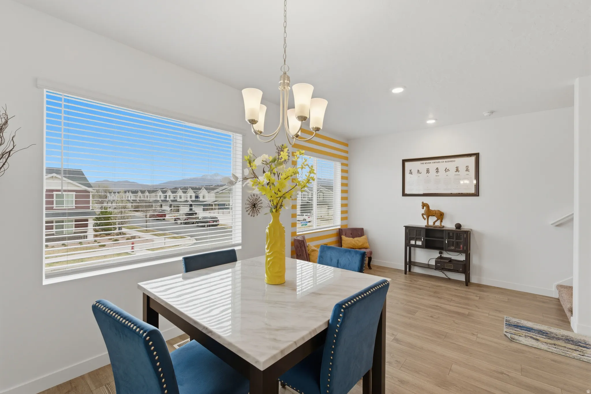 Dining area featuring light wood-style floors and suspended lighting