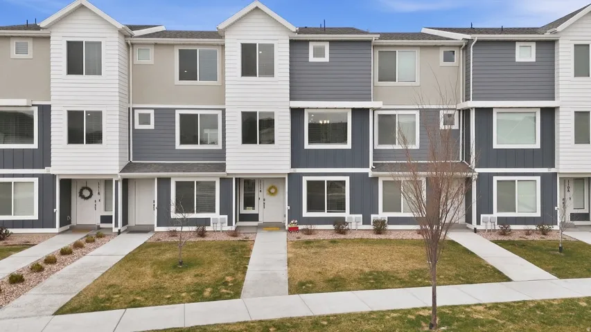 Traditional home featuring a residential view, board and batten siding, and a front yard