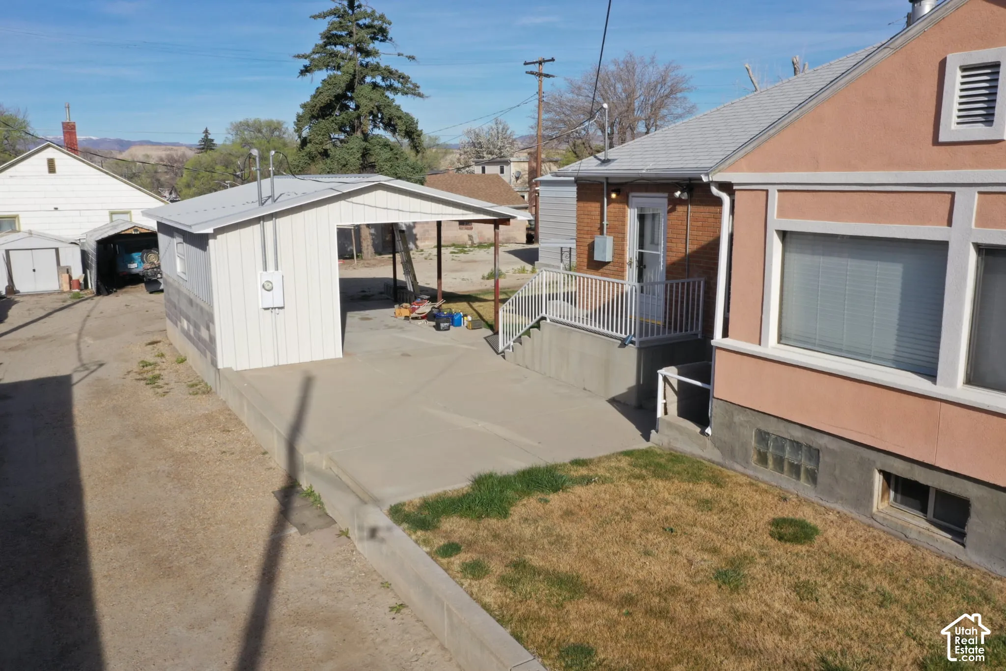 View of property exterior featuring a storage shed and brick siding