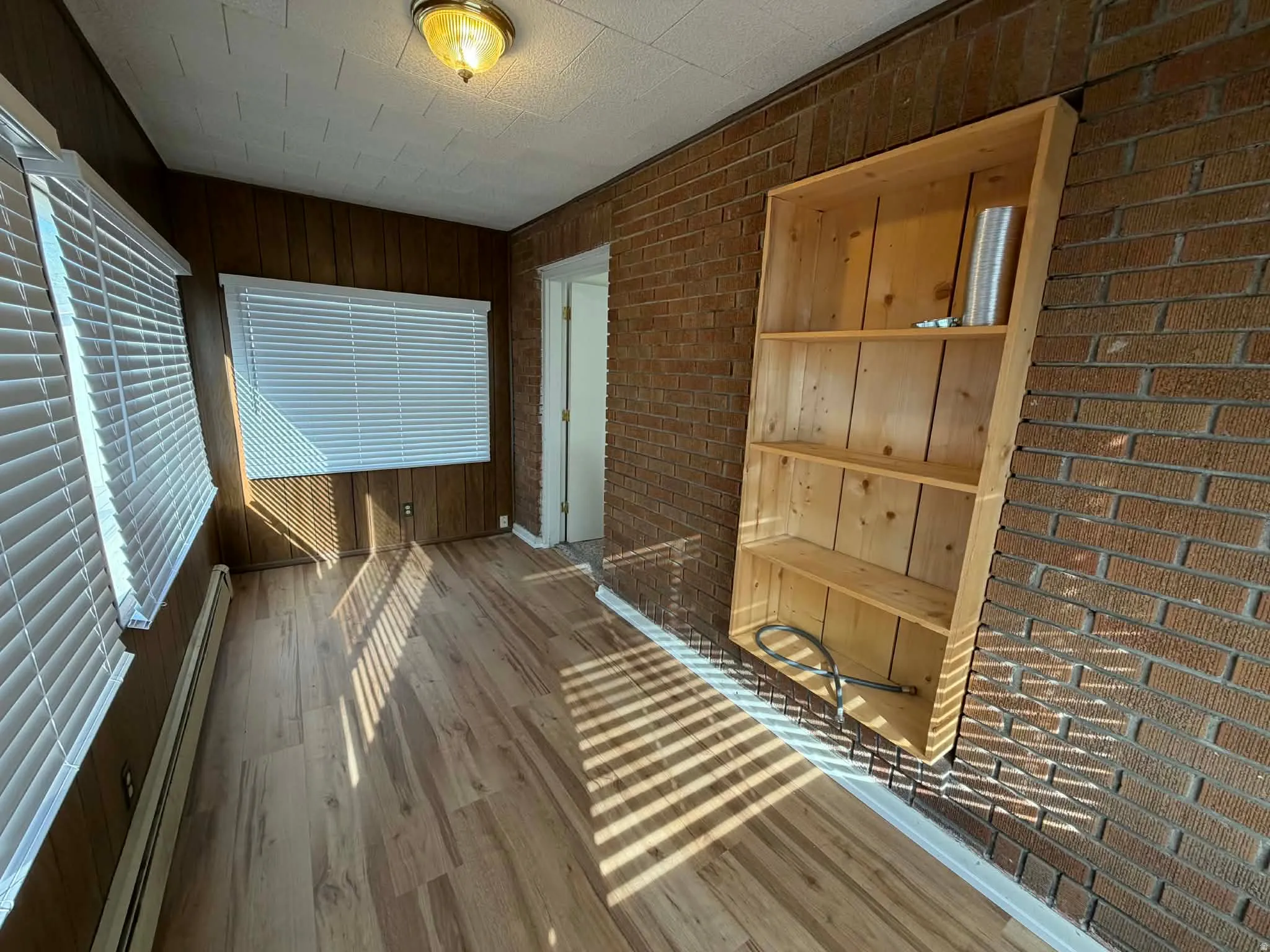 Unfurnished sunroom featuring a baseboard radiator