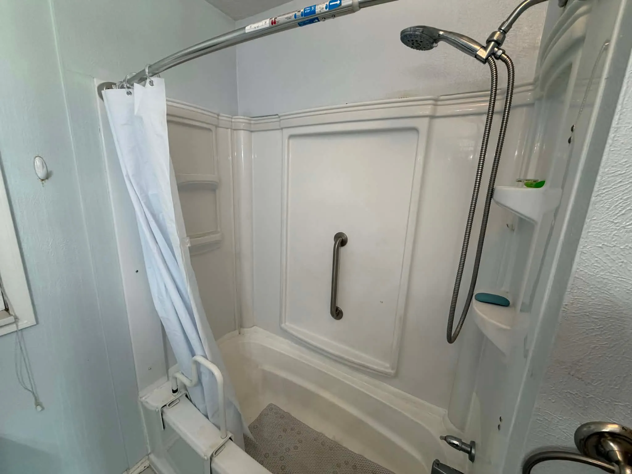 Full bathroom featuring a textured wall