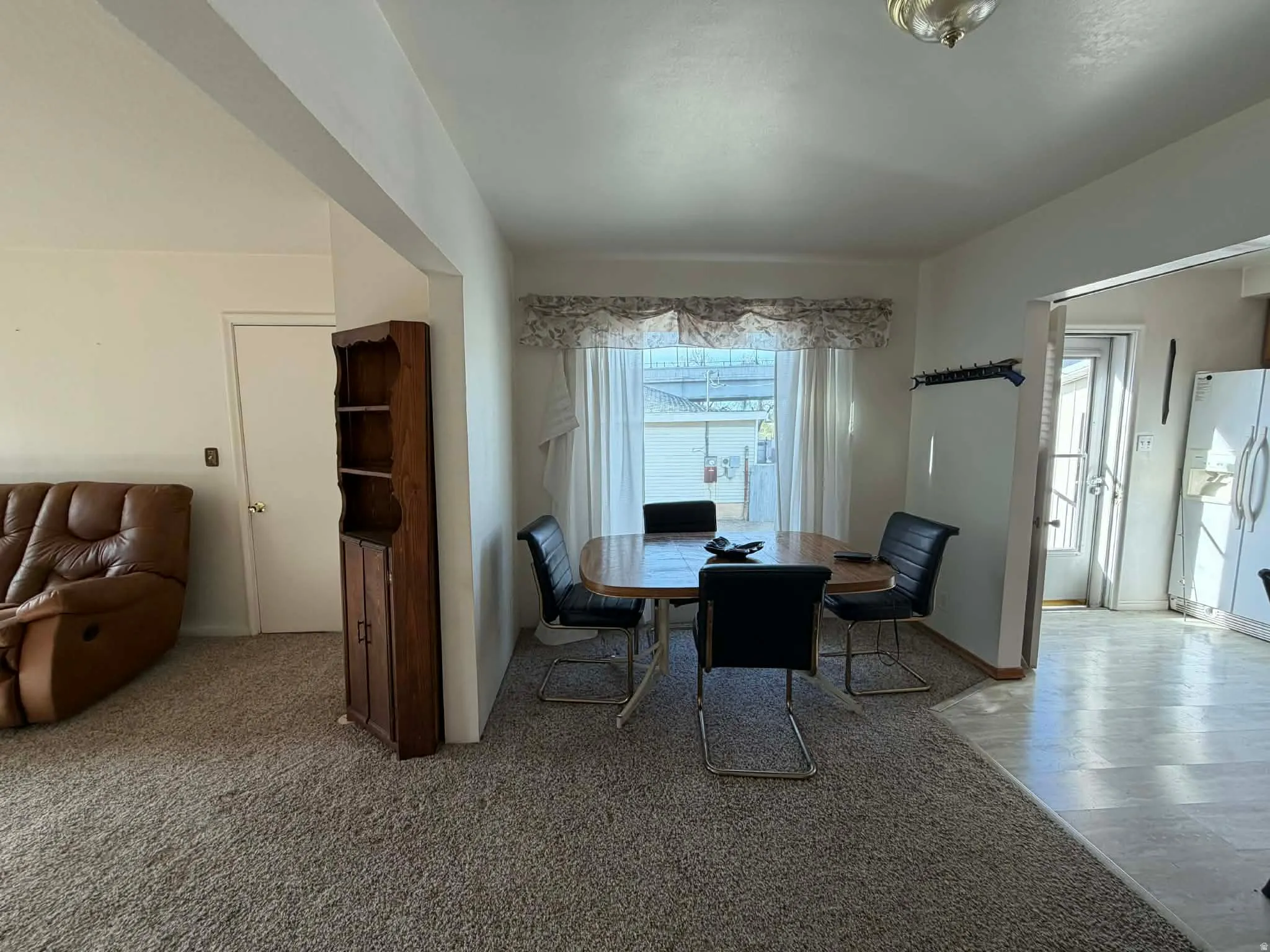 Dining room featuring light carpet