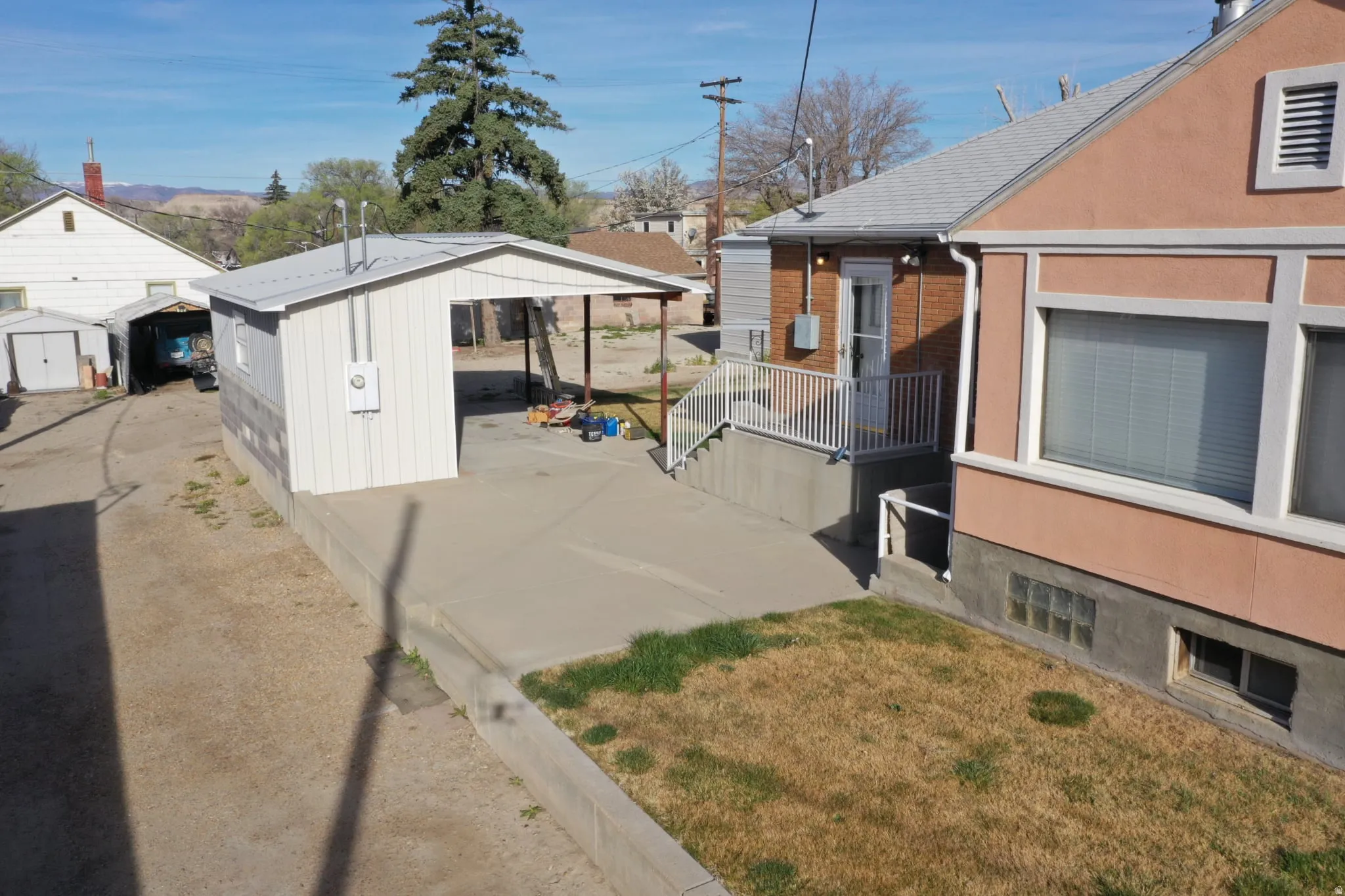 View of property exterior featuring a storage shed and brick siding