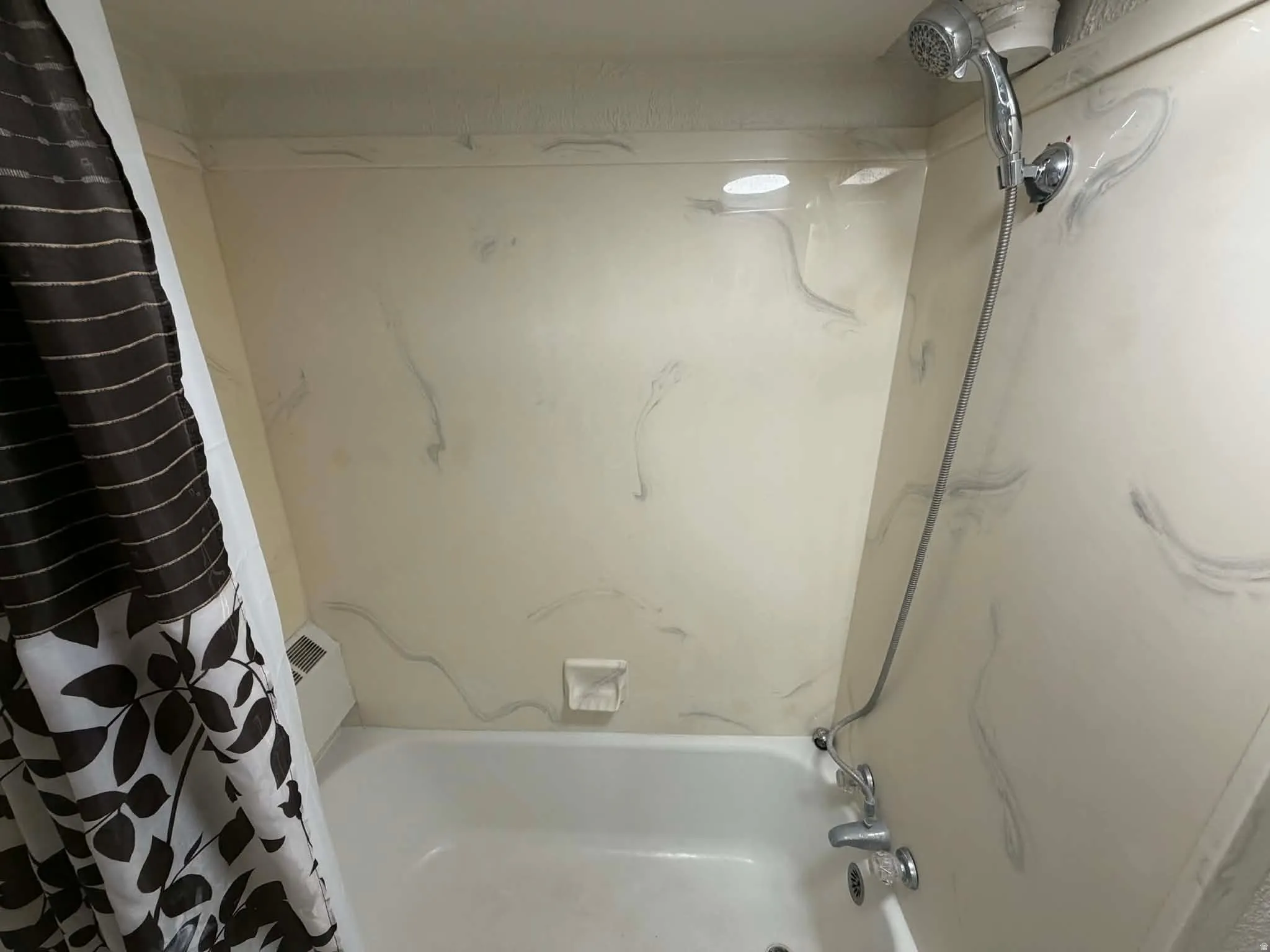 Bathroom featuring shower / bath combo with shower curtain