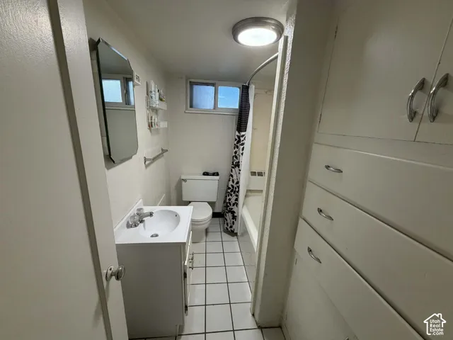 Full bathroom featuring vanity, light tile patterned floors, and shower / bath combo