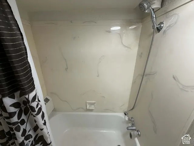 Bathroom featuring shower / bath combo with shower curtain