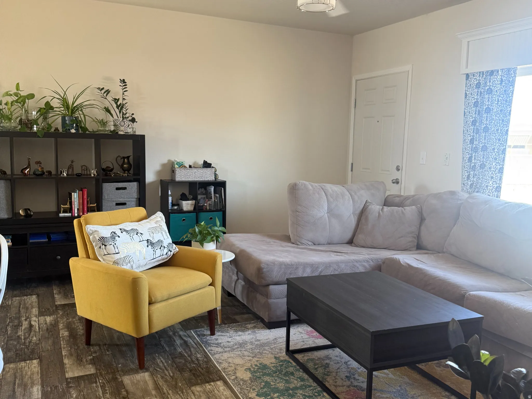 Living area featuring hardwood / wood-style flooring and ceiling fan