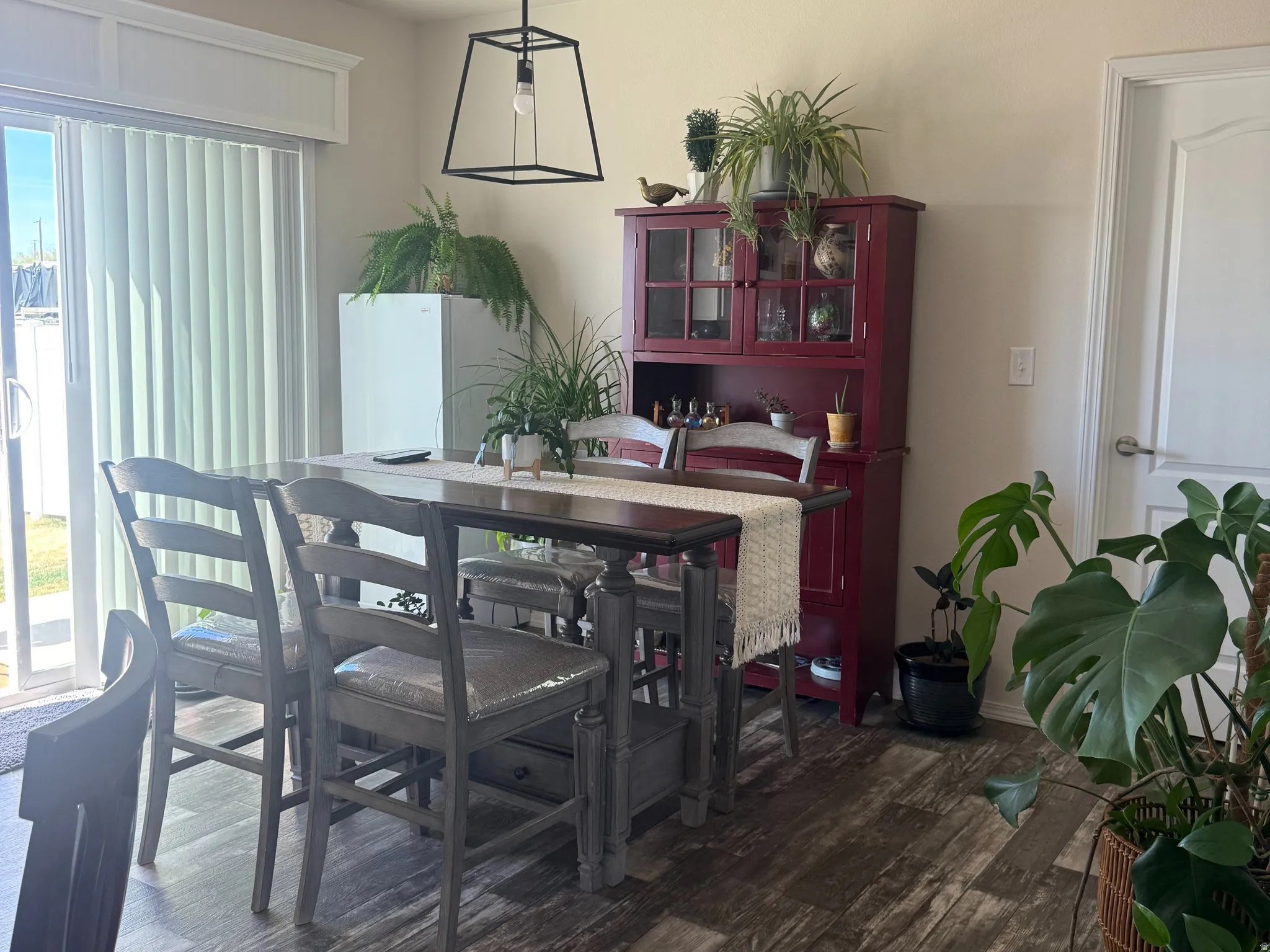 Dining space featuring dark wood-style floors