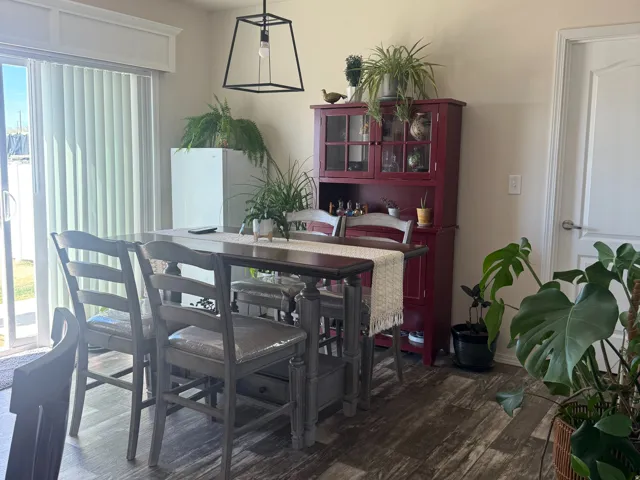 Dining space featuring dark wood-style floors