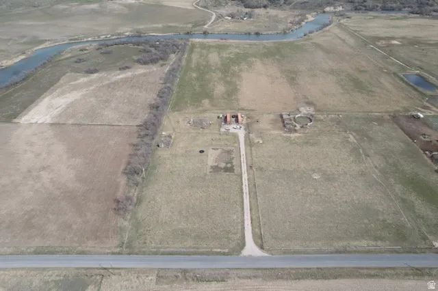 Aerial view of property's location featuring rural landscape and a nearby body of water