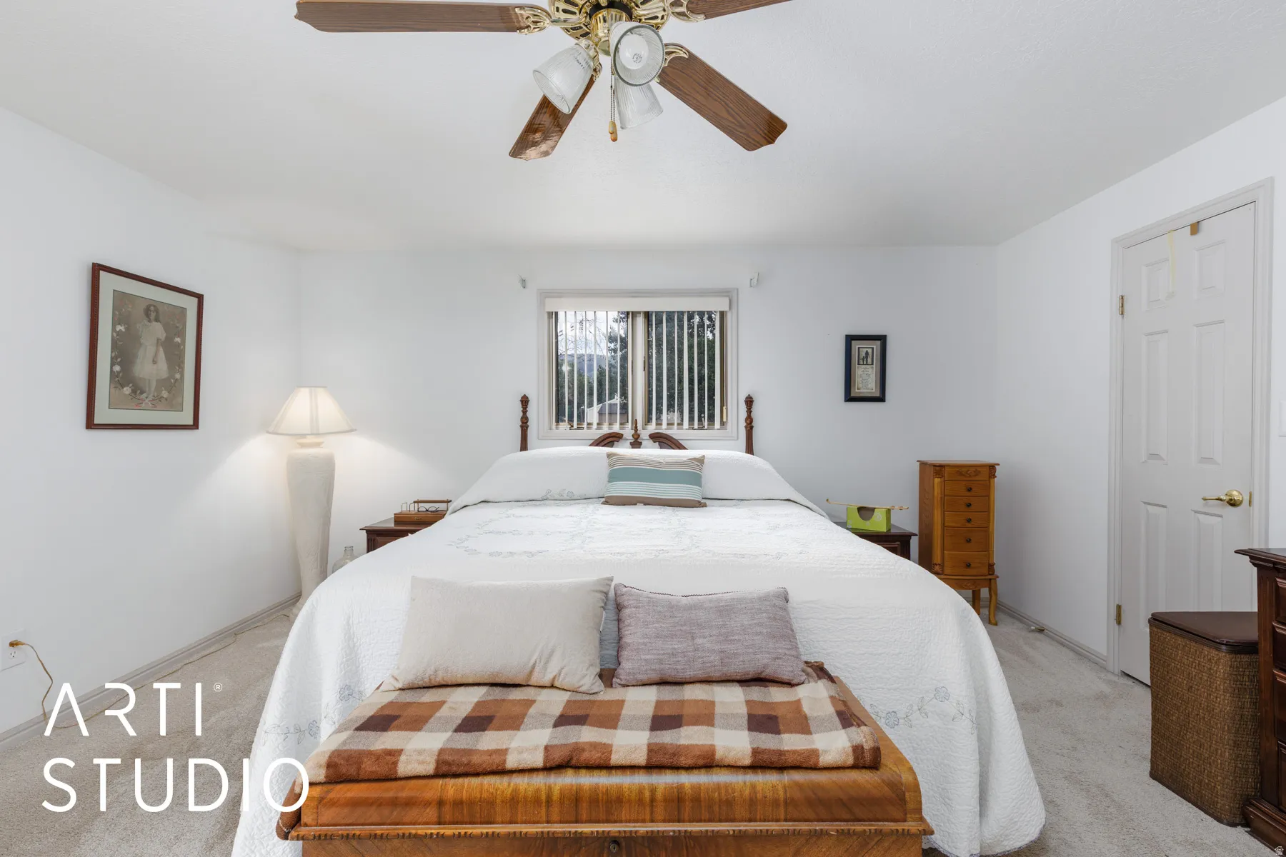 Primary bedroom featuring carpet and a ceiling fan & walk-in closet