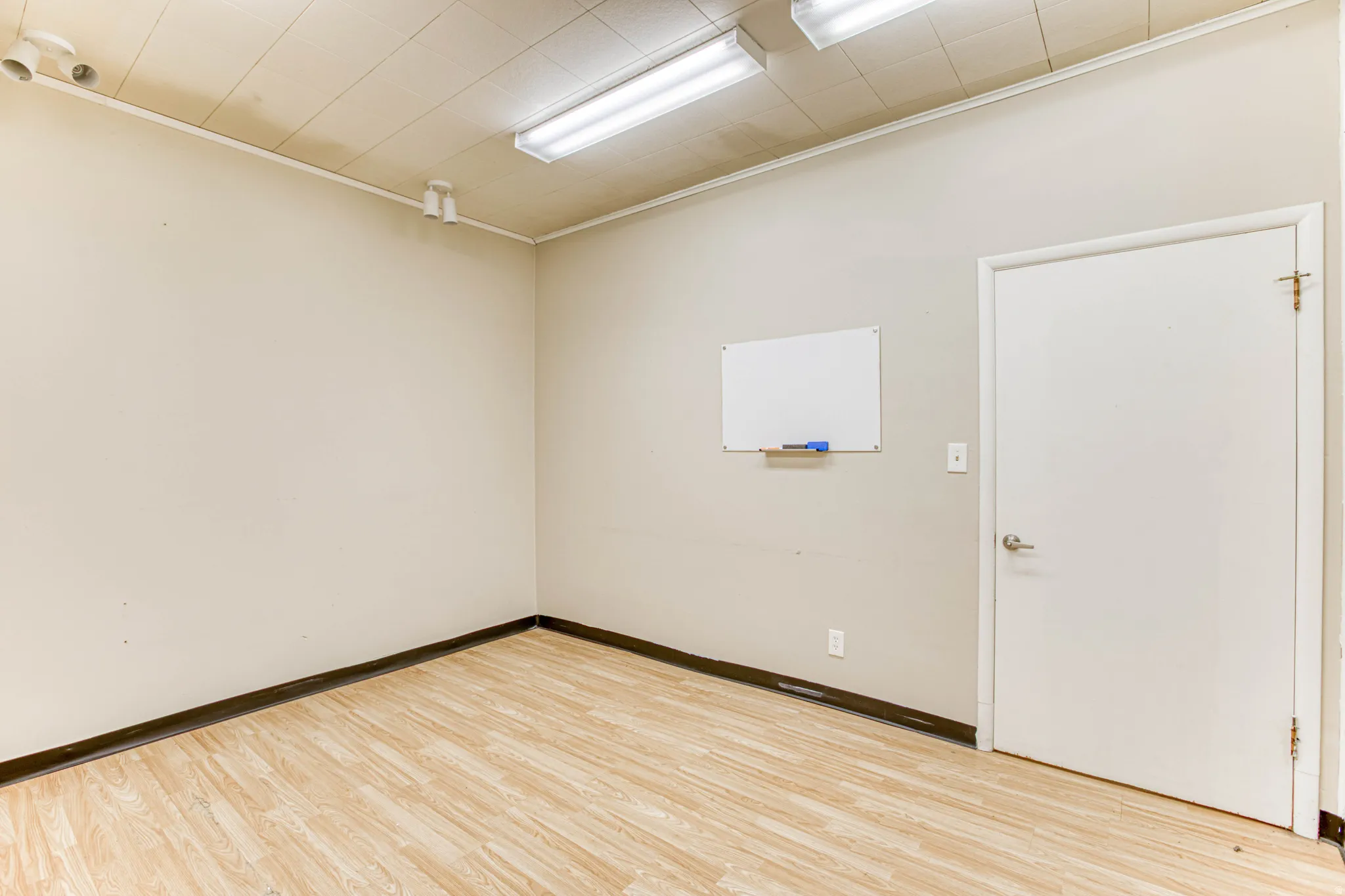Empty room featuring light wood-style floors and ornamental molding