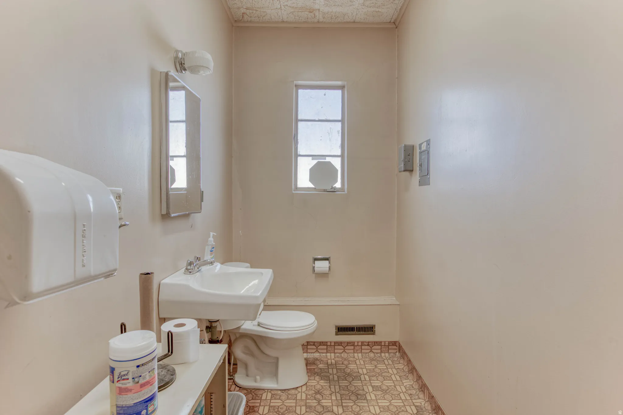 Half bathroom with toilet and a sink