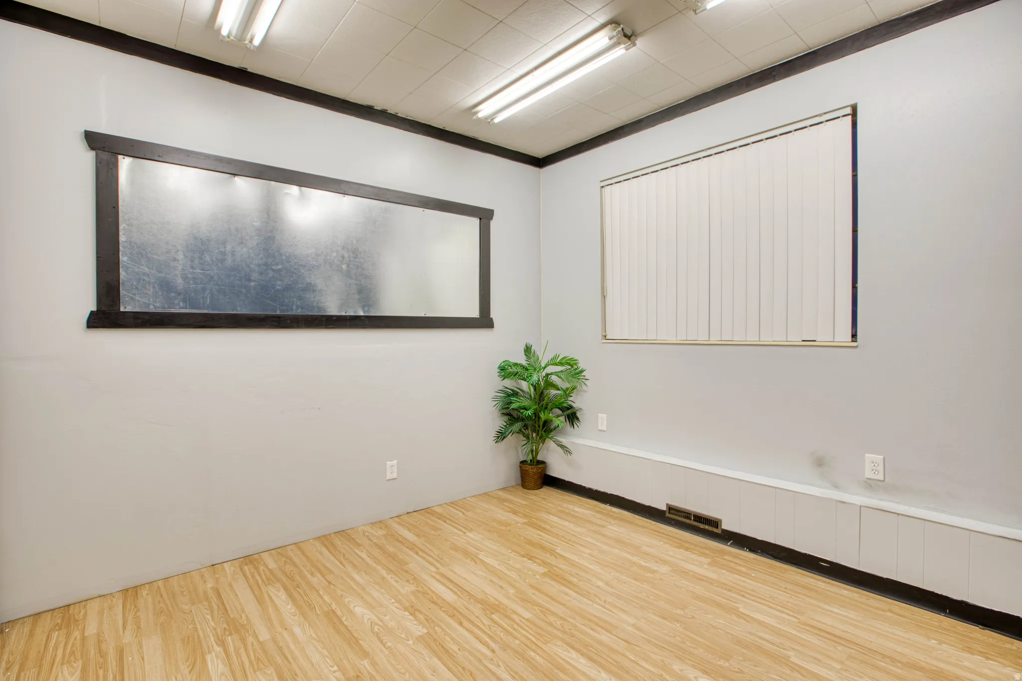 Unfurnished room featuring light wood-style flooring