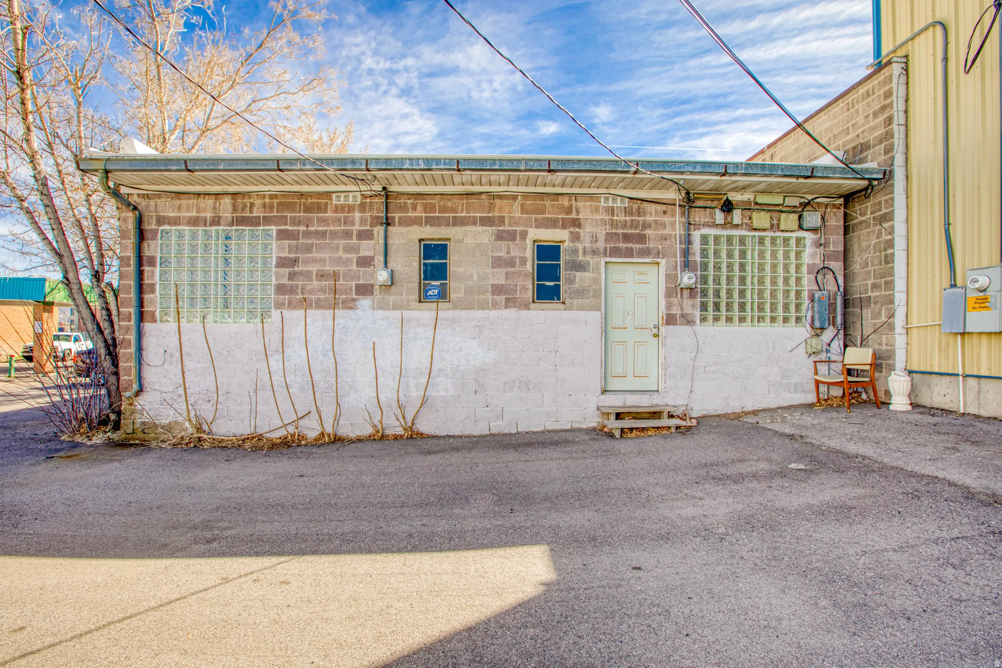 Exterior space featuring concrete block siding and entry steps