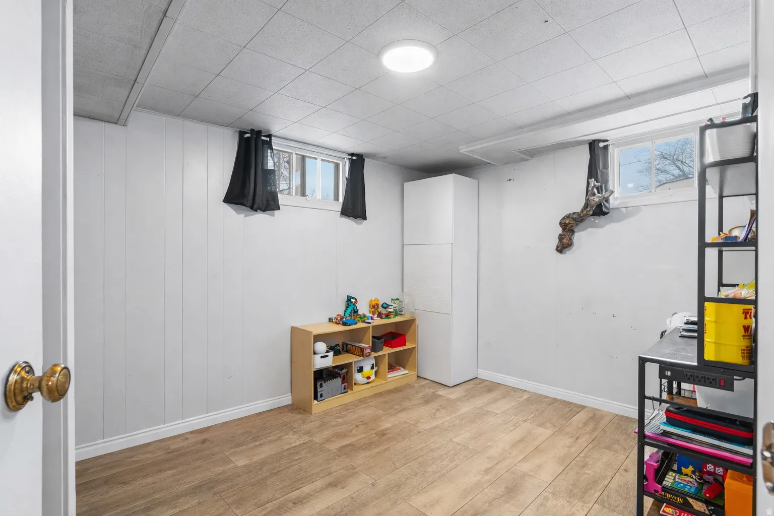 Game room with light wood-style flooring and baseboards