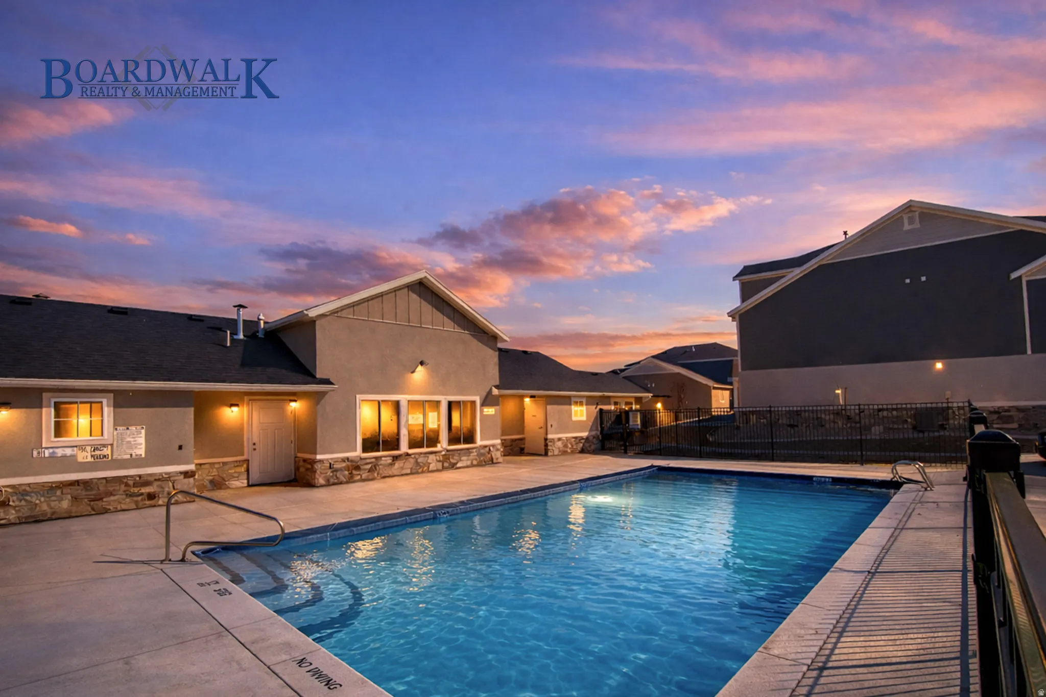 Pool at dusk featuring a patio area and a community pool