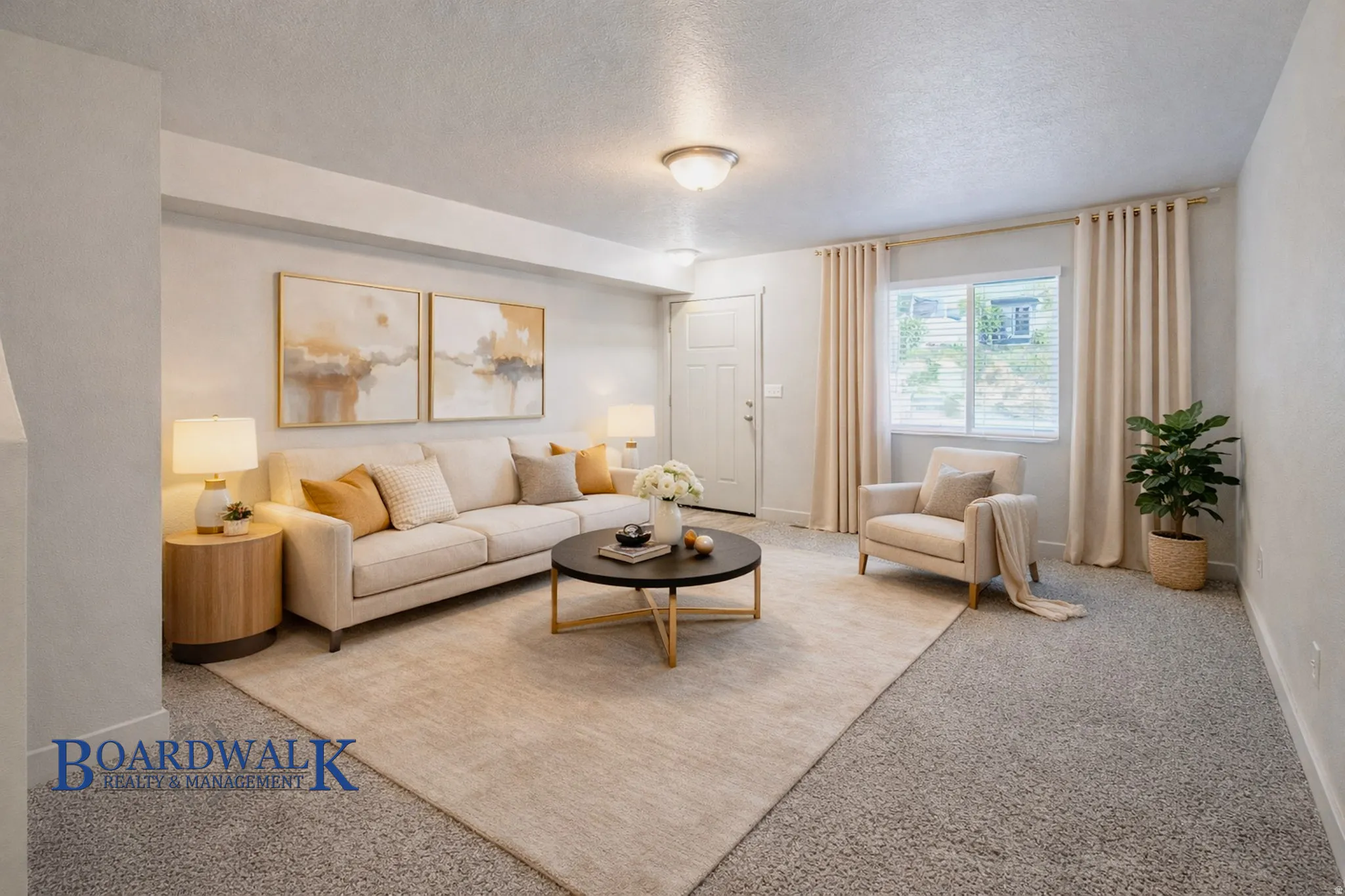 Carpeted living area featuring a textured ceiling and baseboards