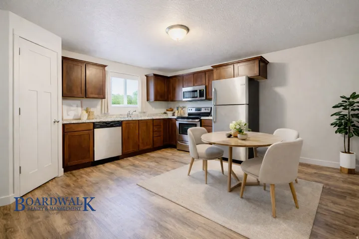 Kitchen with stainless steel appliances, light wood-type flooring, a textured ceiling, and dark wood finish cabinetry