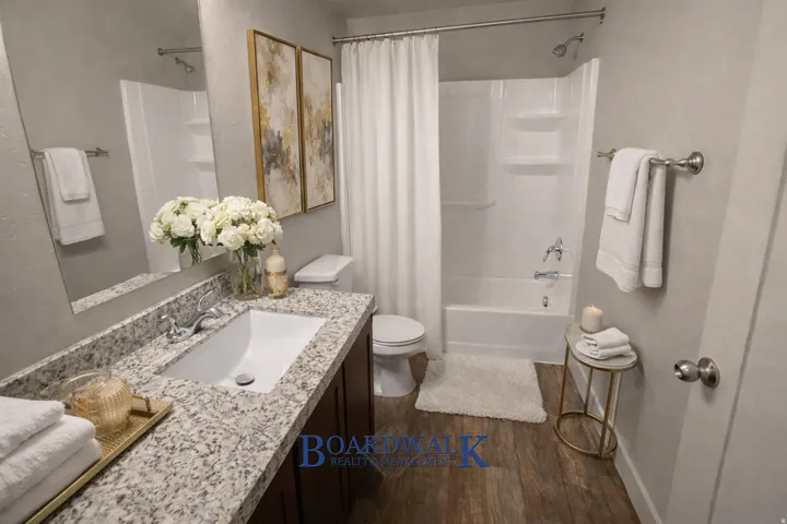 Bathroom featuring vanity, dark wood-style floors, and shower / bath combo
