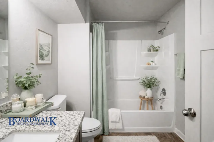 Full bathroom with shower / tub combo, vanity, and dark wood-type flooring