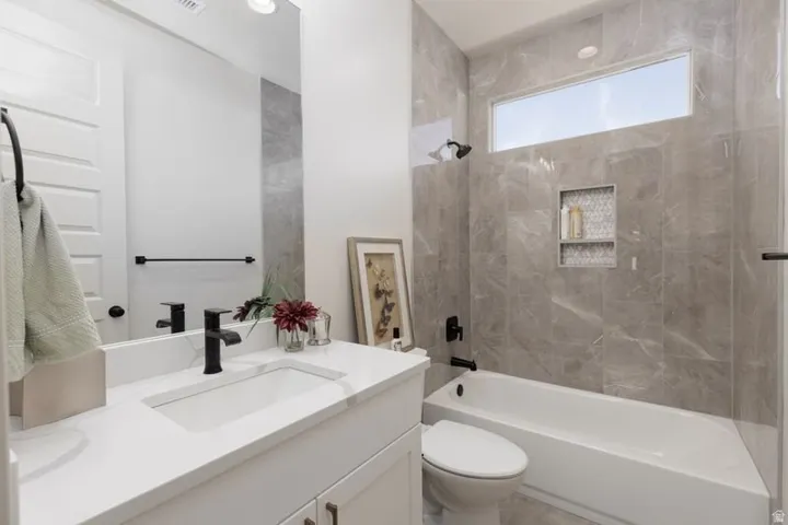 Full bath featuring vanity and tub / shower combination
