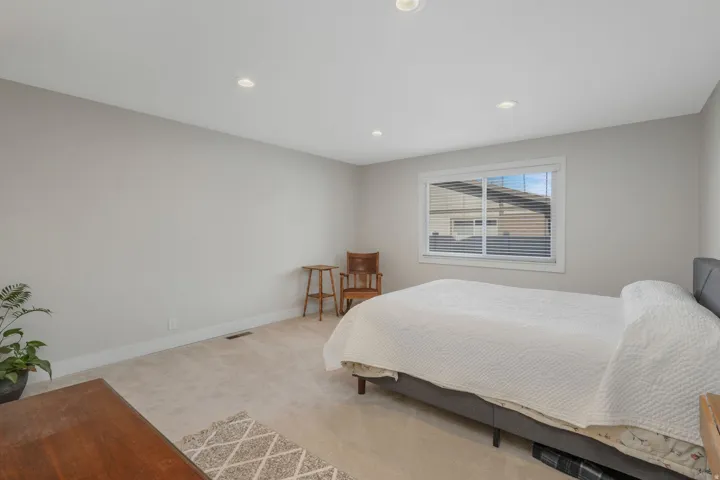 Bathroom featuring a textured ceiling, vanity, shower / bath combo, and light tile patterned floors