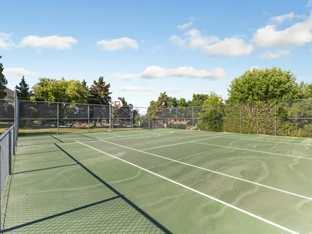 View of tennis court featuring community basketball court