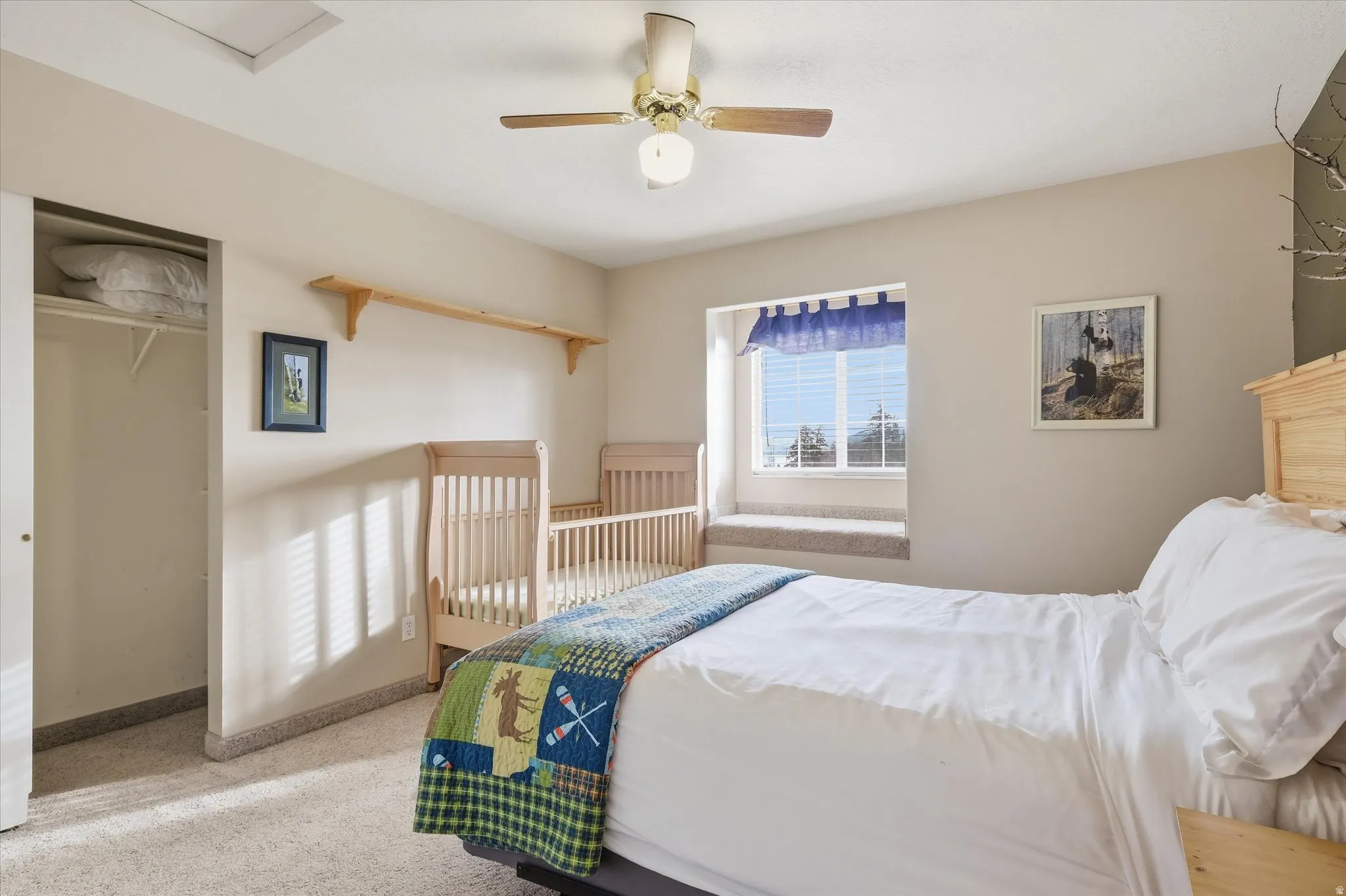 Bedroom with a ceiling fan, light carpet, and a closet