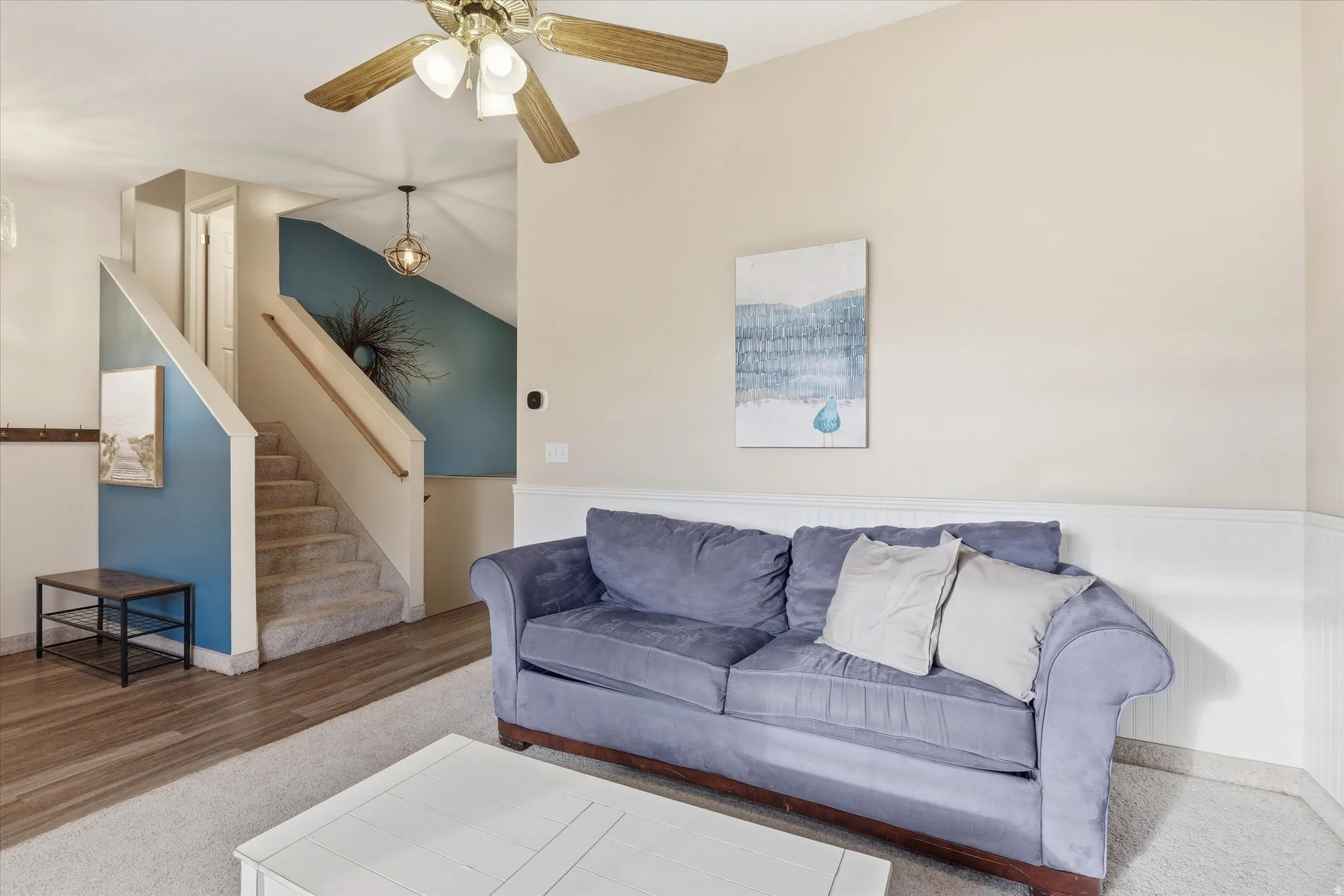Living room featuring ceiling fan, lofted ceiling, and wood finished floors