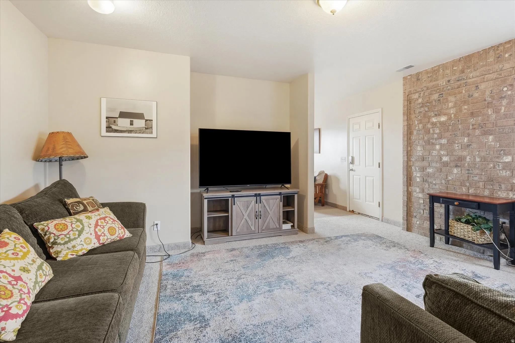 Carpeted living room with a fireplace and baseboards