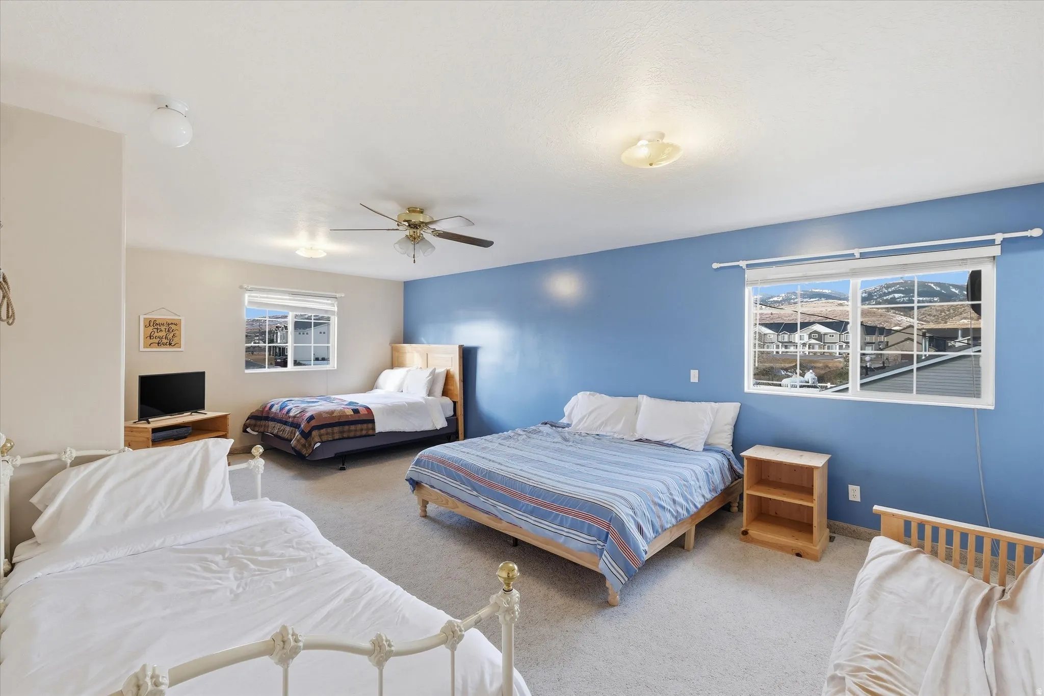 Carpeted bedroom featuring baseboards and ceiling fan