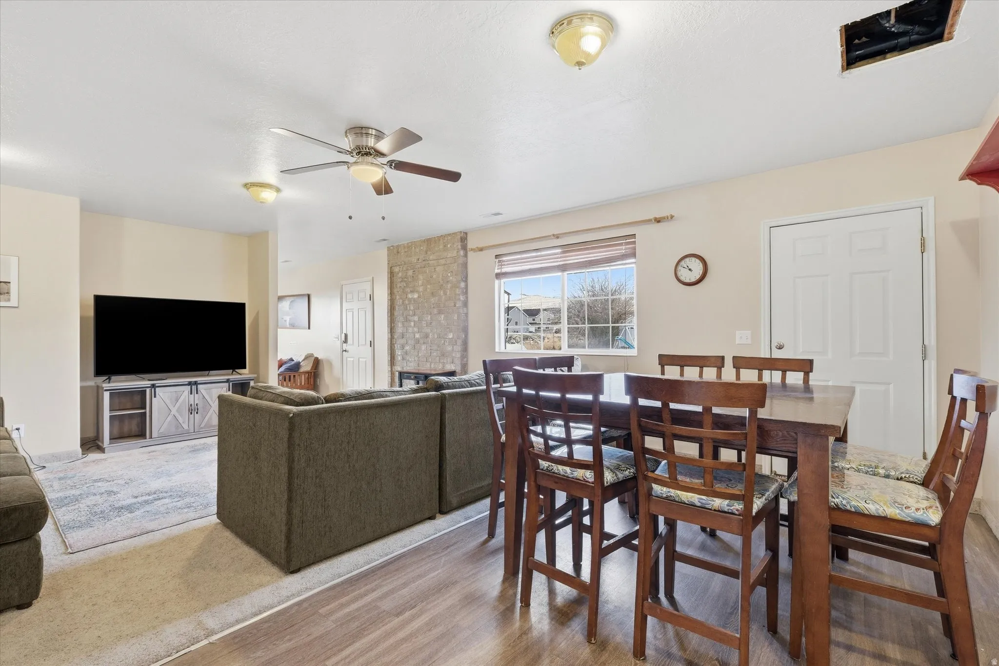 Dining area with light wood-style floors and a ceiling fan